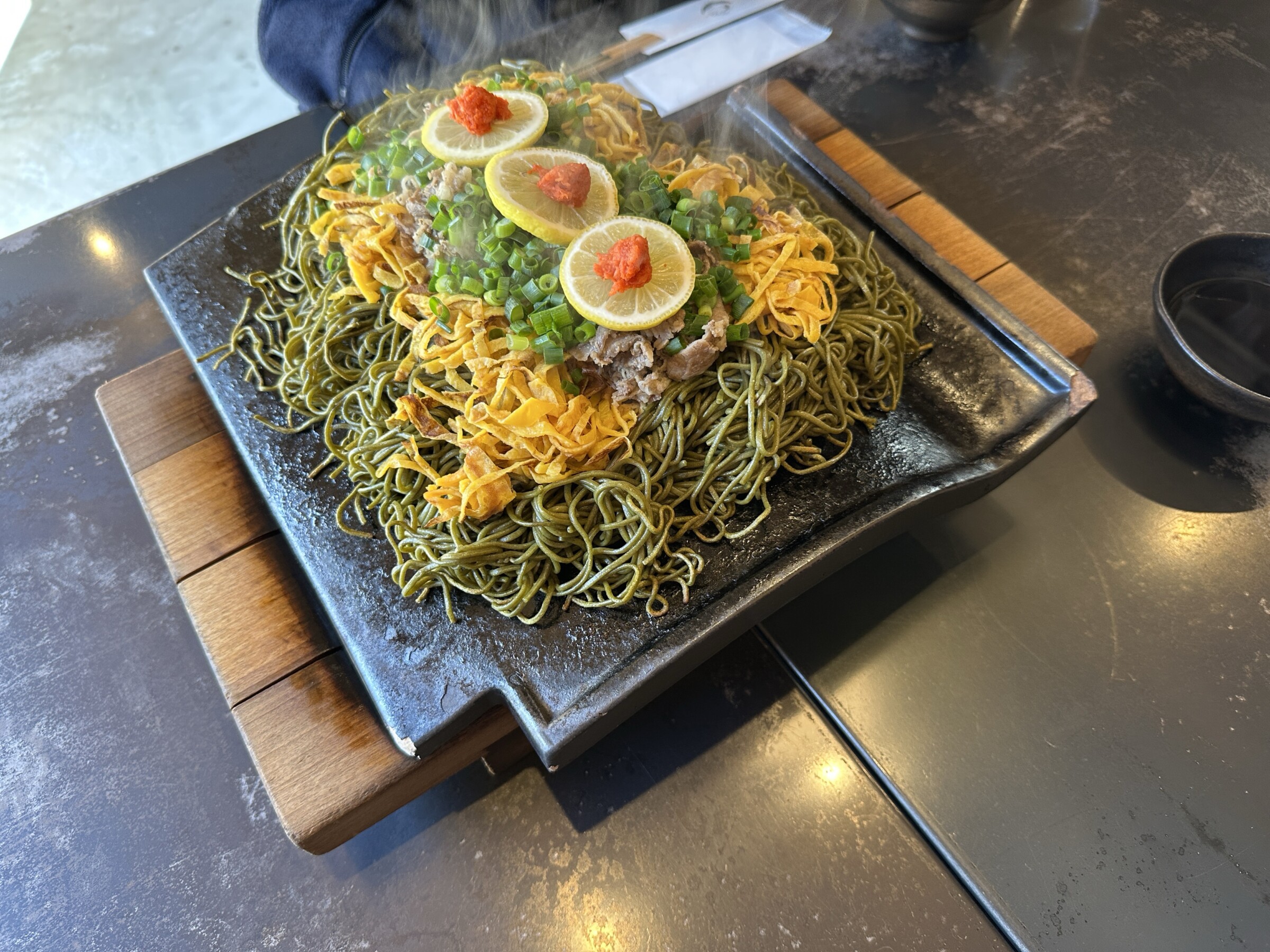Noodles, beef and eggs on a rooftree dish