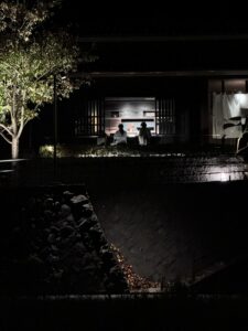 Two people with backs to camera sitting at a bar