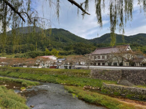 Tsuwano river with tree lined hills and buildings